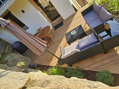 an overhead view of a deck with a couch and an umbrella at Apartment in Saint-Gervais close to gondola in Saint-Gervais-les-Bains