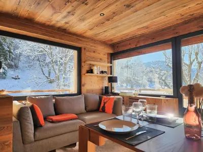 a living room with a couch and a table at Reflets de Megève in Megève