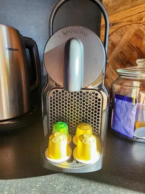 a tea kettle with four yellow cups in it at Reflets de Megève in Megève