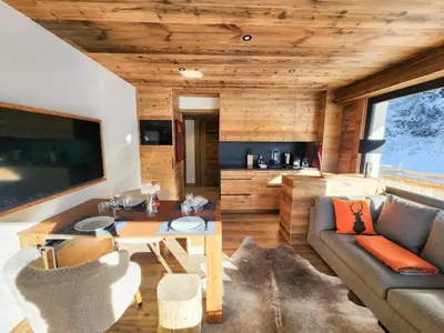 a living room with a couch and a table at Reflets de Megève in Megève