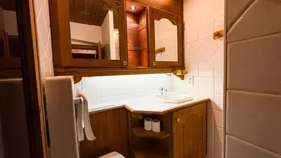 a small bathroom with a sink and a mirror at Appartement Avec Sauna in Chamonix-Mont-Blanc
