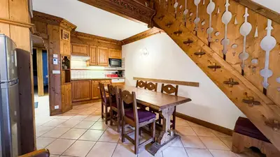 a kitchen with a wooden table and chairs at Appartement Avec Sauna in Chamonix-Mont-Blanc