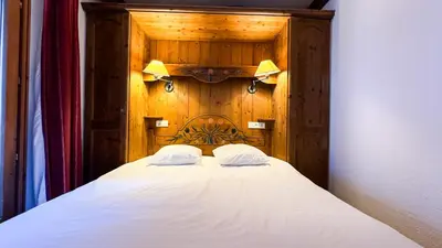 a bed with two pillows on top of it at Appartement Avec Sauna in Chamonix-Mont-Blanc