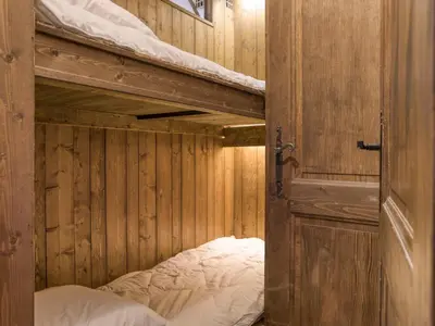 a couple of bunk beds in a wooden room at Studio cabine à Megève pour 4 pers, avec balcon, animaux admis, proche télécabine - FR-1-453-323 in Megève