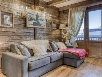 a living room with a couch and wooden walls at Appartement Pratique Centre Megève - 4 Pers - Animaux Bienvenus - FR-1-453-324 in Megève