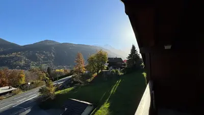 a view of a road and mountains from a building at Appartement Proche Des Pistes in Saint-Gervais-les-Bains