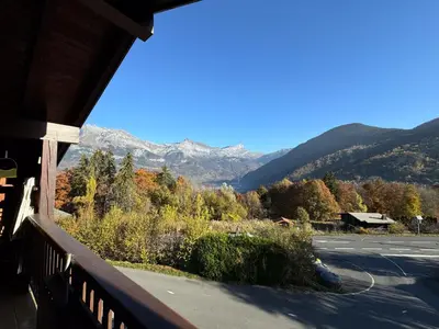 a view of the mountains from a porch at Appartement Proche Des Pistes in Saint-Gervais-les-Bains