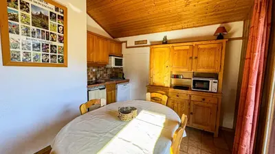 a small kitchen with a table and a microwave at Appartement Proche Des Pistes in Saint-Gervais-les-Bains