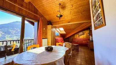 a room with a table and chairs and a balcony at Appartement Proche Des Pistes in Saint-Gervais-les-Bains