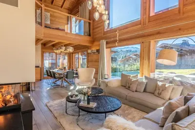 a living room with a couch and a table at Chalet La Petite Forêt in Megève