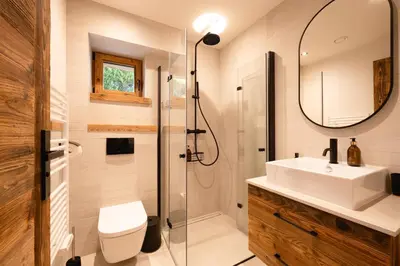 a bathroom with a sink and a toilet and a mirror at Chalet Angel - Chamonix in Chamonix-Mont-Blanc