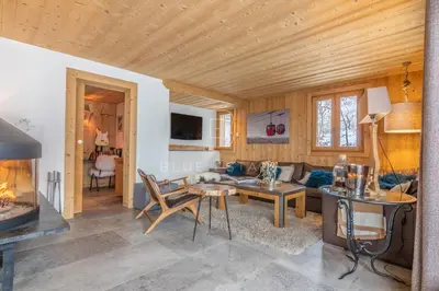 a bedroom with a bed and a wooden ceiling at Chalet Le Hameau - Megève in Demi-Quartier
