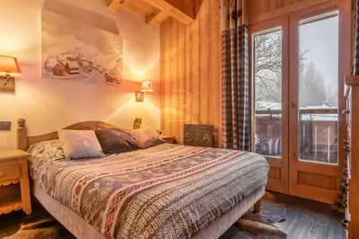 a wooden sauna with a bench in the middle at Chalet Le Hameau - Megève in Demi-Quartier