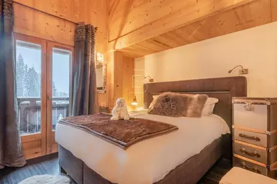 a kitchen with a large island with blue chairs at Chalet Le Hameau - Megève in Demi-Quartier