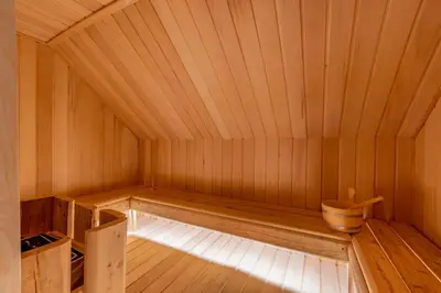a kitchen with wooden cabinets and a counter in a cabin at Chalet du Jaillet in Demi-Quartier