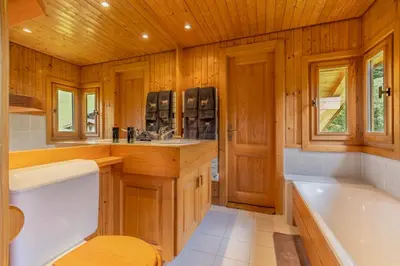 a living room with a fireplace in a log cabin at Chalet du Jaillet in Demi-Quartier