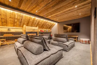 a living room with three couches and a tv at Chalet du Jaillet in Demi-Quartier