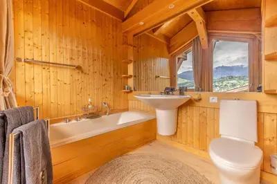 a bathroom with a tub and a sink and a toilet at Chalet du Jaillet in Demi-Quartier
