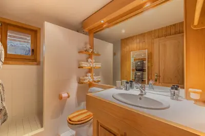 a kitchen and dining room with a wooden table and chairs at Chalet du Jaillet in Demi-Quartier
