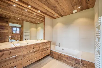 a bathroom with a tub and a sink at Chalet Les Marmottes in Combloux
