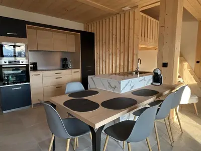 a kitchen with a large wooden table and chairs at Appartement Dolce Vista in Passy