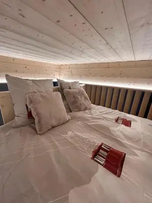a large white bed with pillows on top of it at Appartement Dolce Vista in Passy