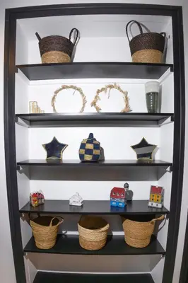 a shelf with baskets and toys on it at Design flat-center of Samoëns in Samoëns