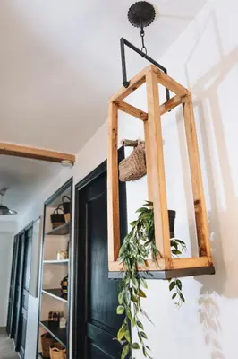 a hanging basket with a plant on a wall at Design flat-center of Samoëns in Samoëns