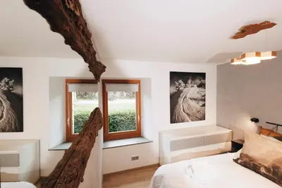 a bedroom with two windows and a bed at Design flat-center of Samoëns in Samoëns
