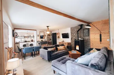a living room with two couches and a dining room at Design flat-center of Samoëns in Samoëns
