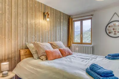 a bedroom with a bed and a window at Appartement Chez Albert situé 25KM Chamonix in Saint-Gervais-les-Bains