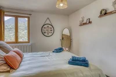 a bedroom with a bed with two towels on it at Appartement Chez Albert situé 25KM Chamonix in Saint-Gervais-les-Bains