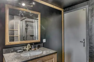 a bathroom with a sink and a mirror at Appartement Chez Albert situé 25KM Chamonix in Saint-Gervais-les-Bains