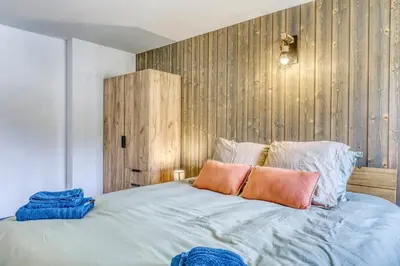 a bedroom with a bed with two pillows on it at Appartement Chez Albert situé 25KM Chamonix in Saint-Gervais-les-Bains