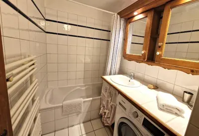 a bathroom with a sink and a washing machine at La Ginabelle 2 - Vue MontBlanc in Chamonix-Mont-Blanc