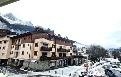 a building on a street with snow on the ground at La Ginabelle 2 - Vue MontBlanc in Chamonix-Mont-Blanc