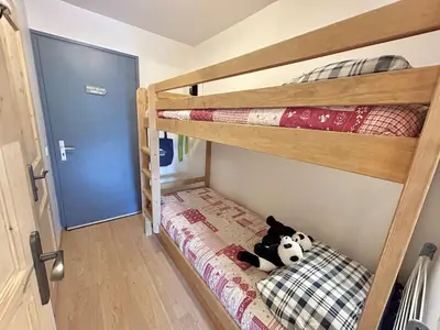 a bedroom with bunk beds with a stuffed panda bear on the bottom bunk at Studio à Megève avec parking souterrain et casier à skis - FR-1-597-189 in Megève