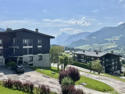 a building with a car parked in front of it at Studio à Megève avec parking souterrain et casier à skis - FR-1-597-189 in Megève