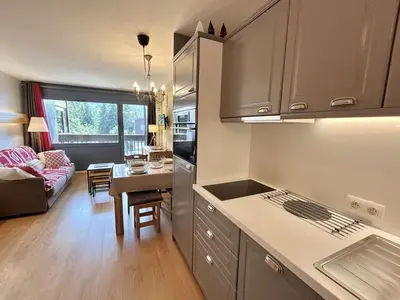a kitchen and living room with a couch and a table at Studio à Megève avec parking souterrain et casier à skis - FR-1-597-189 in Megève