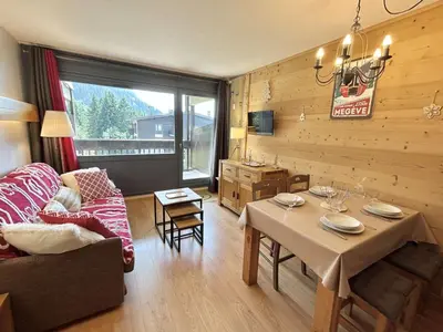 a living room with a table and a couch at Studio à Megève avec parking souterrain et casier à skis - FR-1-597-189 in Megève