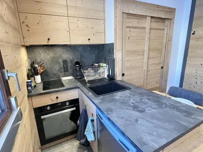 a kitchen with a counter and a sink and a stove at Studio confortable proche du centre avec parking, navette et randonnées à Megève - FR-1-597-190 in Megève