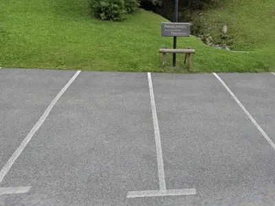 a parking lot with a sign in the middle at Studio confortable proche du centre avec parking, navette et randonnées à Megève - FR-1-597-190 in Megève