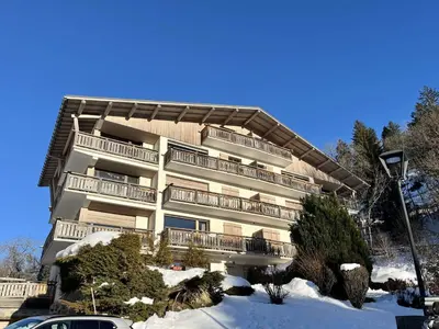 a large building with snow in front of it at Studio confortable proche du centre avec parking, navette et randonnées à Megève - FR-1-597-190 in Megève