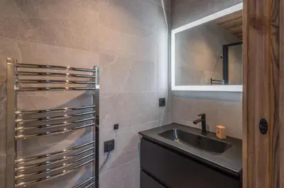 a bathroom with a sink and a mirror at Duplex des Rois - Welkeys in Megève