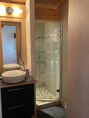 a bathroom with a sink and a shower at Chalet La Pioleute Megève in Megève