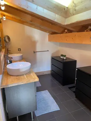 a bathroom with a sink and a counter with a sink at Chalet La Pioleute Megève in Megève