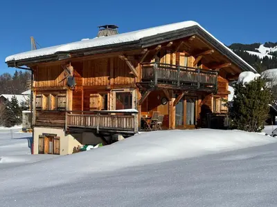 a large log cabin with snow on the ground at Chalet La Pioleute Megève in Megève