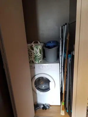 a washing machine with pots and pans on top of it at Le Haut du Rosay in Sallanches