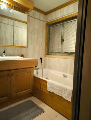 a bathroom with a tub and a sink at Apartment in residence near the Mont d'Arbois in Megève