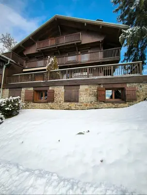 a house with snow in front of it at Apartment in residence near the Mont d'Arbois in Megève